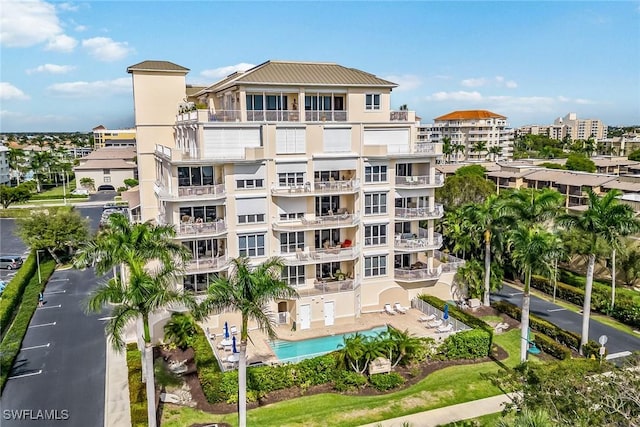 view of building exterior with a community pool