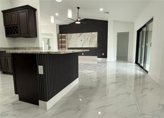 kitchen with pendant lighting, lofted ceiling, stainless steel fridge, ceiling fan, and light stone counters