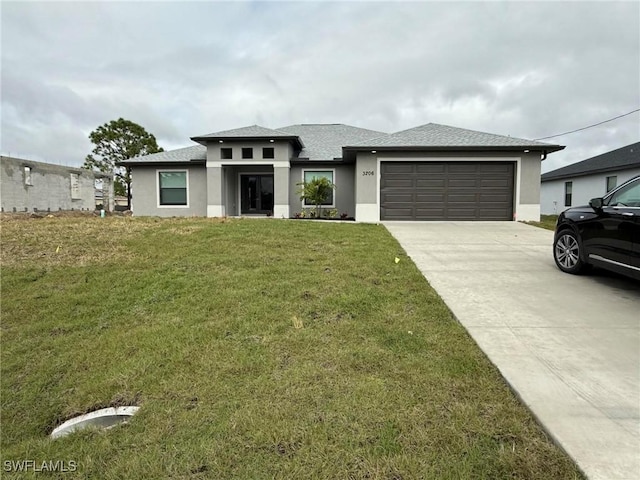 prairie-style house featuring a garage and a front yard