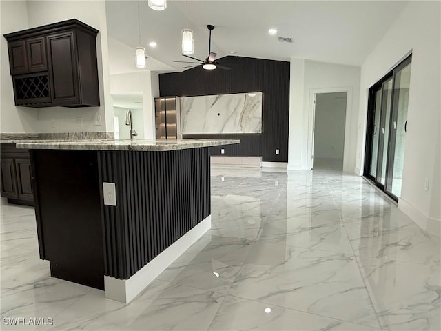 kitchen with lofted ceiling, sink, kitchen peninsula, pendant lighting, and ceiling fan