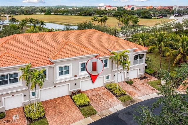 birds eye view of property with a water view