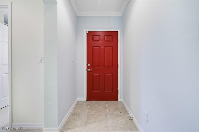 entryway with crown molding and light tile patterned floors