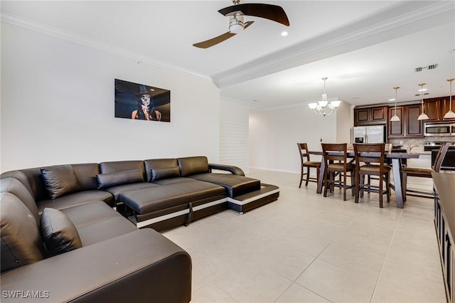 living room featuring crown molding, ceiling fan with notable chandelier, and light tile patterned flooring