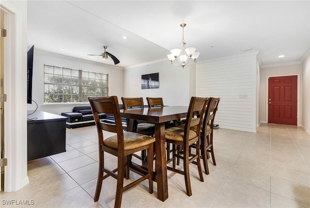 tiled dining space featuring ornamental molding and ceiling fan