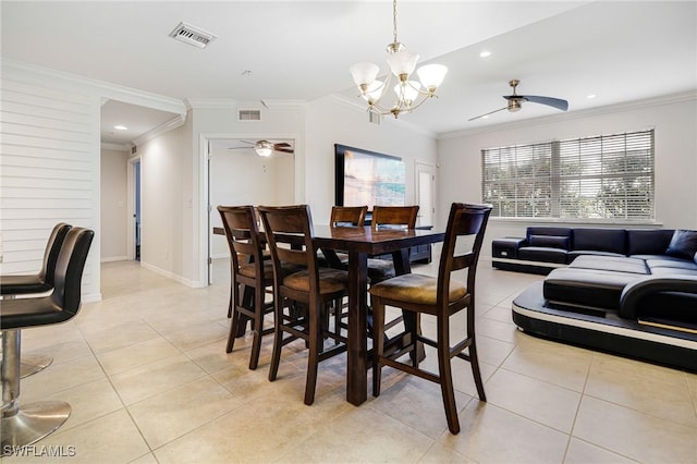 tiled dining area featuring crown molding and ceiling fan