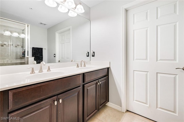 bathroom featuring tile patterned floors, a chandelier, a shower with door, and vanity