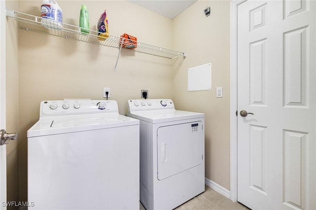 clothes washing area with washer and dryer