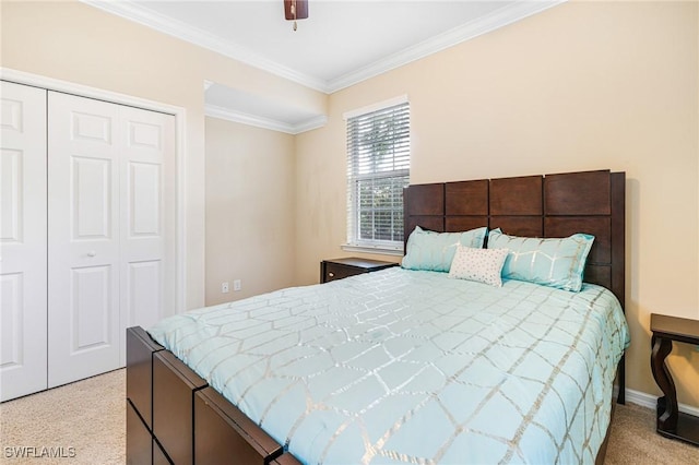 bedroom with light carpet, ornamental molding, a closet, and ceiling fan