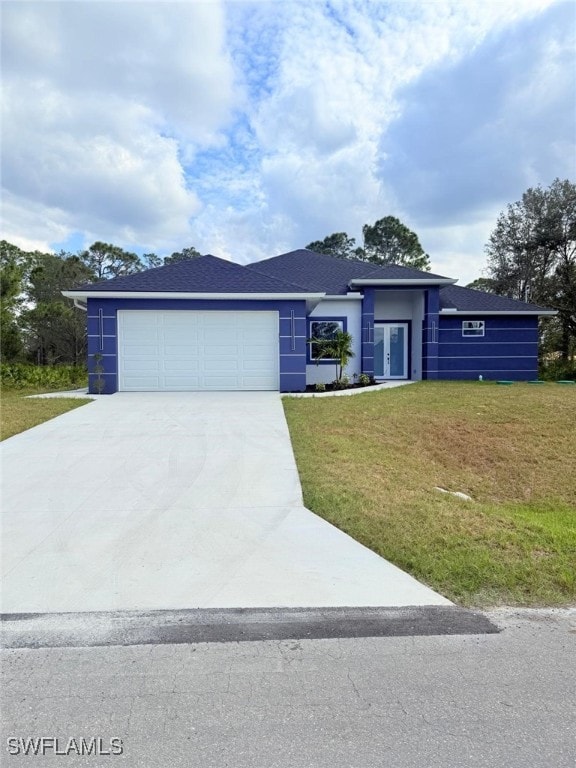 view of front of house featuring a garage and a front lawn