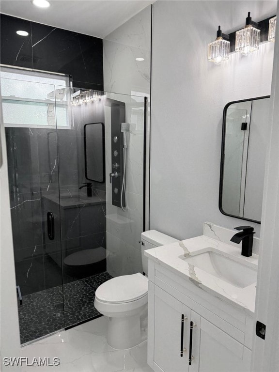 bathroom featuring vanity, an enclosed shower, and toilet