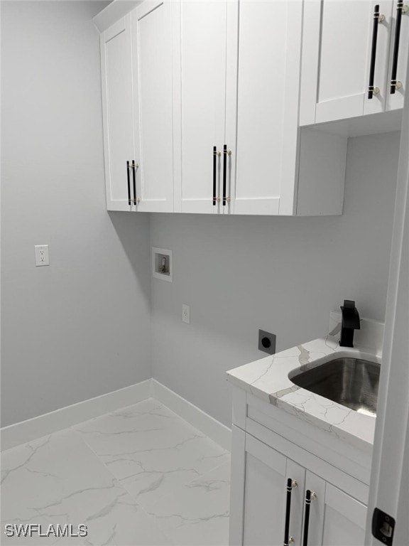 laundry area with sink, hookup for a washing machine, cabinets, and hookup for an electric dryer