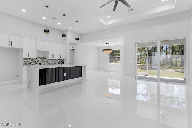 3702 Flora Ave N, Lehigh Acres, FL 33971 - unfurnished living room featuring light marble finish flooring, ceiling fan, and recessed lighting
