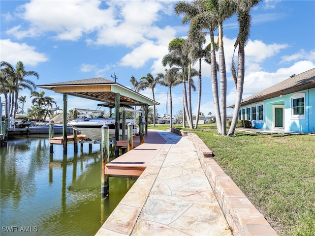 view of dock with a water view and a lawn