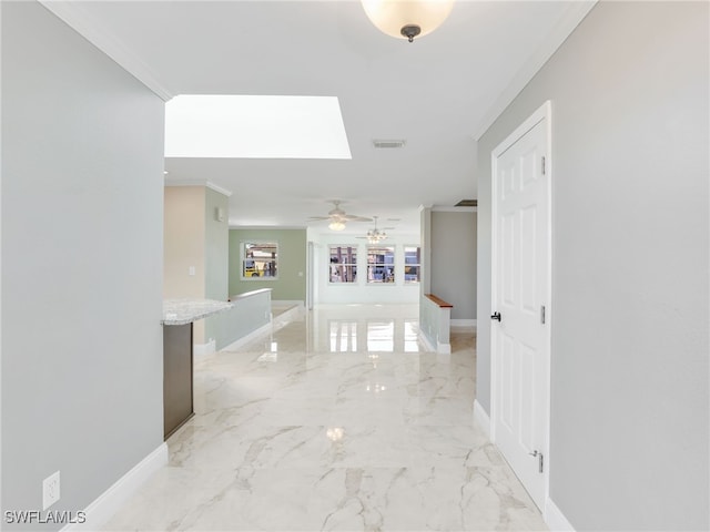 corridor featuring crown molding and a skylight