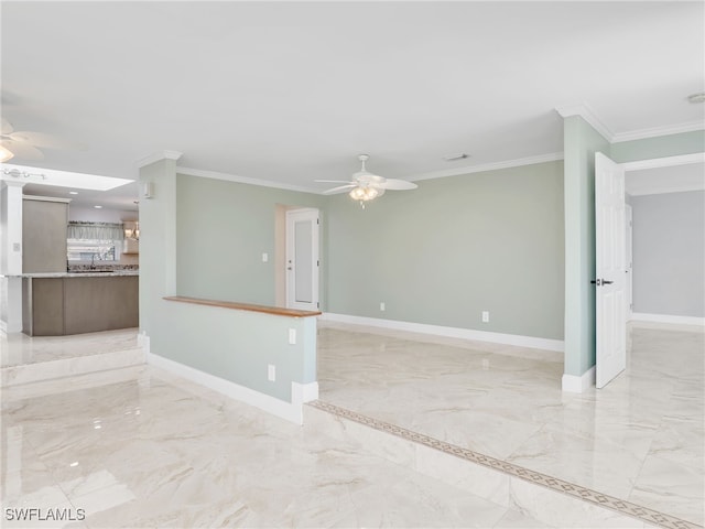 empty room featuring ornamental molding and ceiling fan