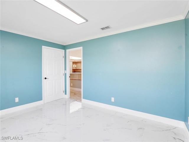 spare room featuring crown molding