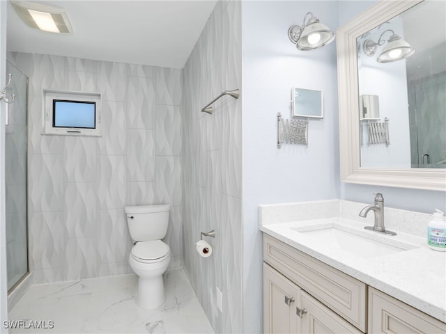 bathroom featuring a shower with door, vanity, and toilet