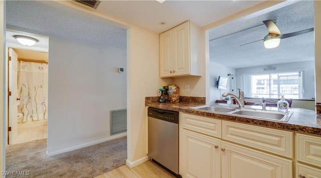 kitchen featuring sink, stainless steel dishwasher, and a textured ceiling