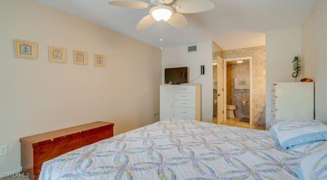 bedroom with ceiling fan and a textured ceiling