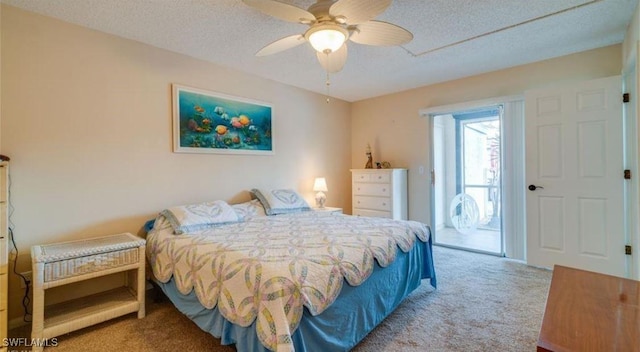 carpeted bedroom featuring access to exterior, a textured ceiling, and ceiling fan