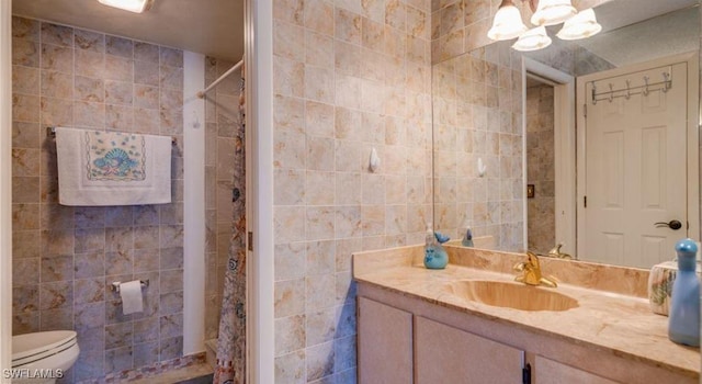 bathroom with walk in shower, toilet, an inviting chandelier, tile walls, and vanity