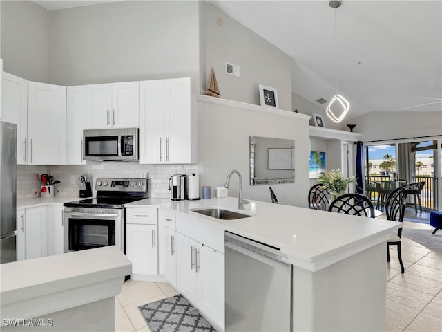 kitchen with white cabinetry, appliances with stainless steel finishes, decorative light fixtures, and sink