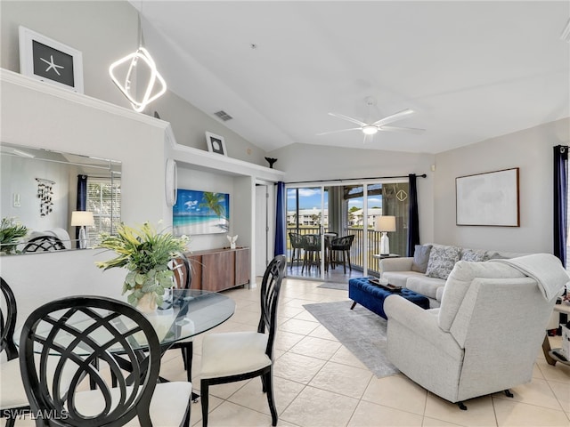 tiled living room with ceiling fan with notable chandelier and vaulted ceiling