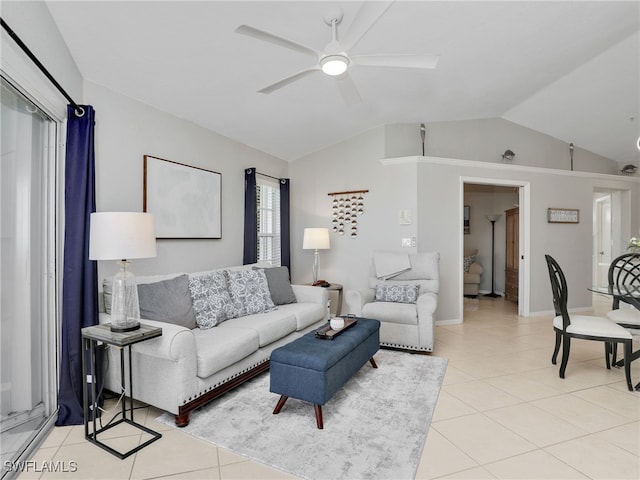 tiled living room with lofted ceiling and ceiling fan