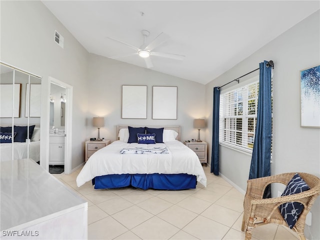 tiled bedroom featuring ceiling fan, ensuite bathroom, and vaulted ceiling