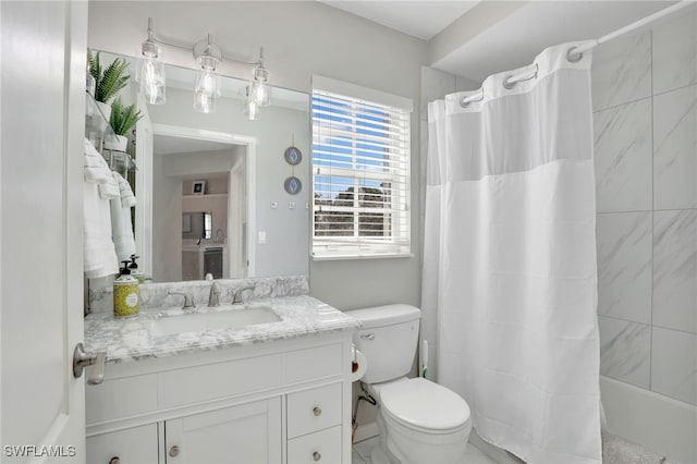 full bathroom featuring vanity, toilet, and shower / bath combo with shower curtain