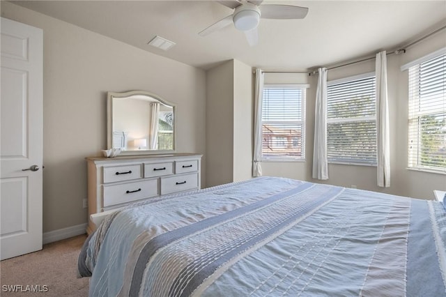 bedroom with ceiling fan and light carpet