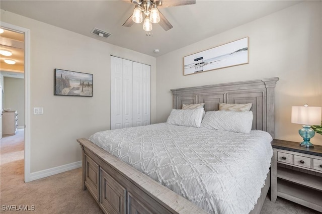 bedroom with light carpet, ceiling fan, and a closet