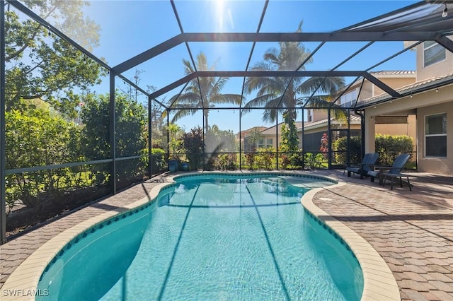 view of pool featuring a patio and glass enclosure