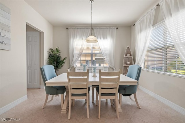 dining space featuring light tile patterned floors and a healthy amount of sunlight