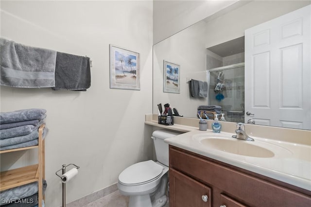 bathroom with toilet, vanity, and walk in shower