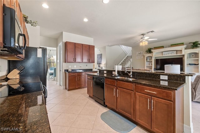 kitchen featuring sink, light tile patterned floors, ceiling fan, dark stone counters, and black appliances