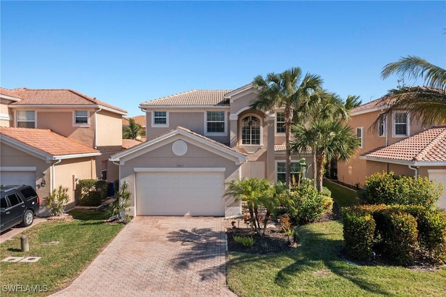 mediterranean / spanish home with a garage and a front yard