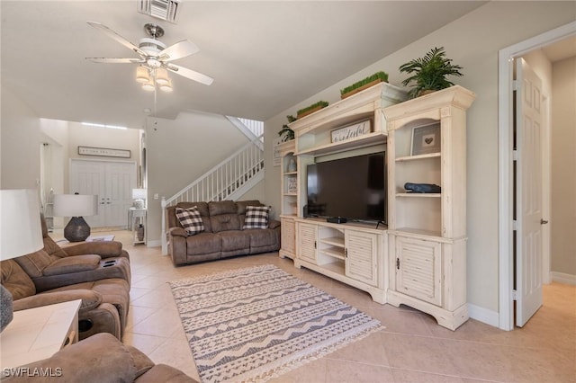 living room with light tile patterned floors and ceiling fan