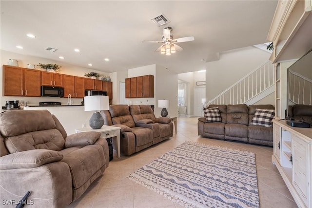 living room with light tile patterned floors and ceiling fan