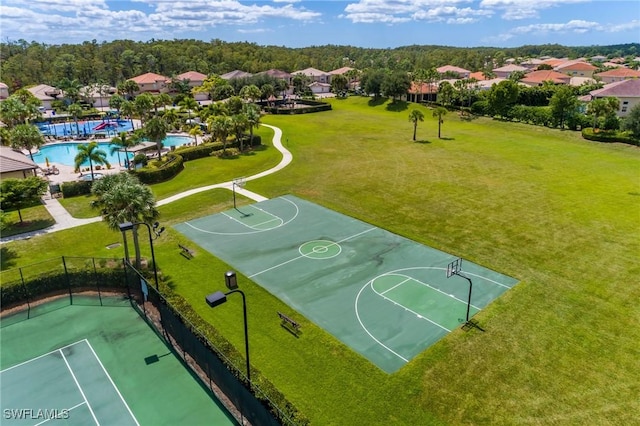 view of basketball court featuring a yard