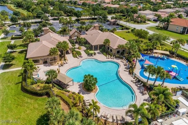 view of pool featuring a water view and a patio