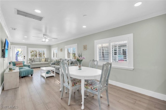 dining room featuring ornamental molding, ceiling fan, and light wood-type flooring