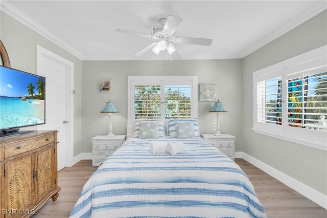 bedroom featuring crown molding, ceiling fan, and light hardwood / wood-style flooring