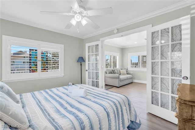 bedroom with hardwood / wood-style flooring, ceiling fan, and ornamental molding