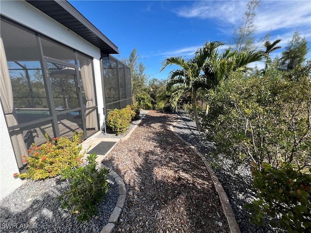 view of yard with glass enclosure