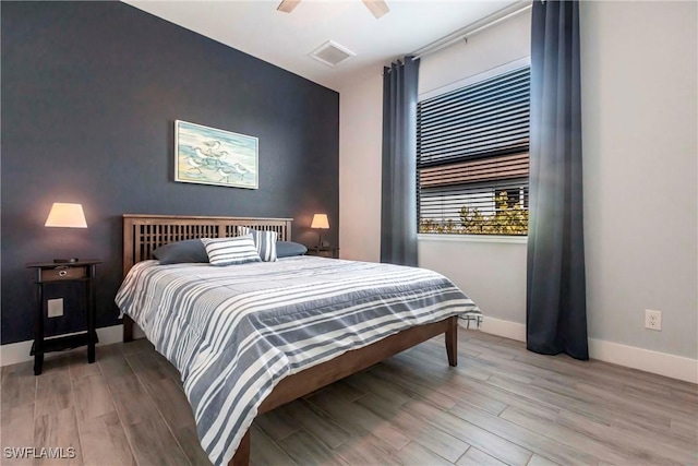 bedroom with hardwood / wood-style flooring and ceiling fan