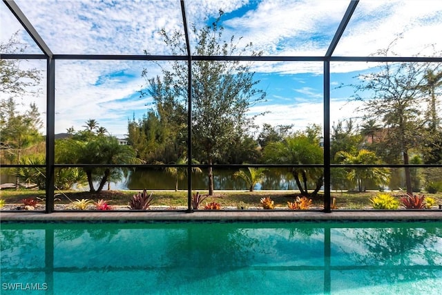 view of pool with a water view and a lanai