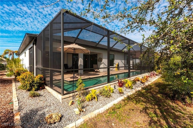 rear view of house with a lanai and a patio