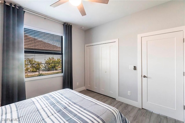 bedroom with light wood-type flooring and ceiling fan