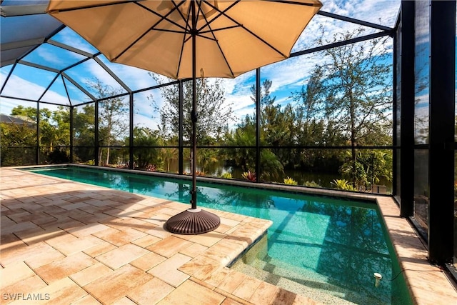 view of swimming pool featuring a patio and glass enclosure